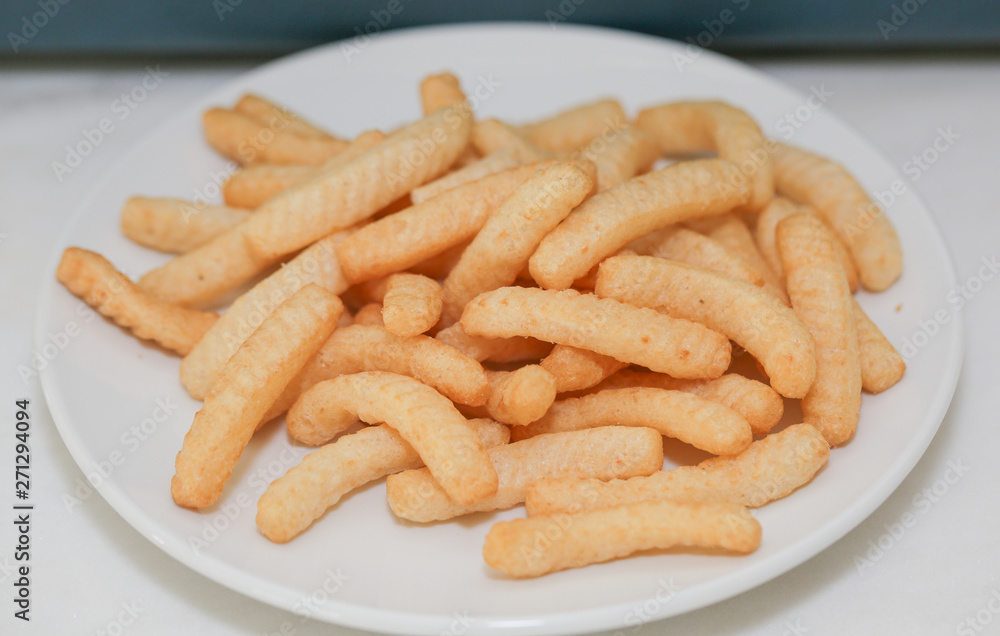 Closeup Shrimp cracker chips on a white paper plate. - Image