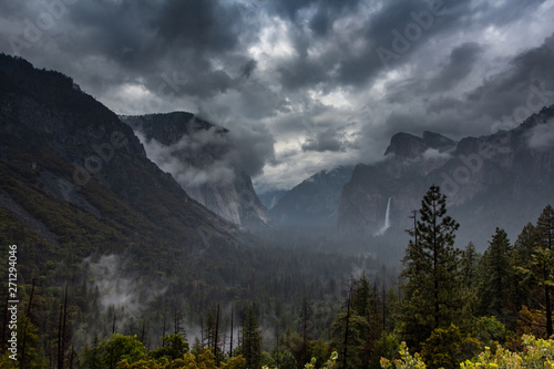 A rainy, moody, shot of Tunnel View and Half Dome in Yosemite National Park, California, USA