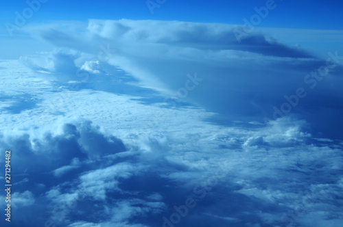 aerial view from plane, blue sky with clouds and sun