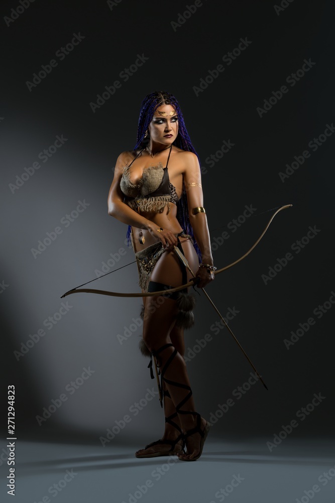 Amazon in lingerie holding bow and arrows