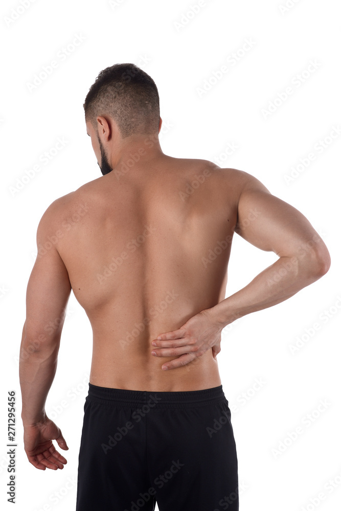 Young man with back pain. The athlete clings to a sore back. Man hurt his back. Sports medicine concept