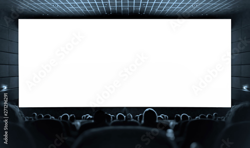 Cinema. White screen in the cinema and the audience watching the movie.