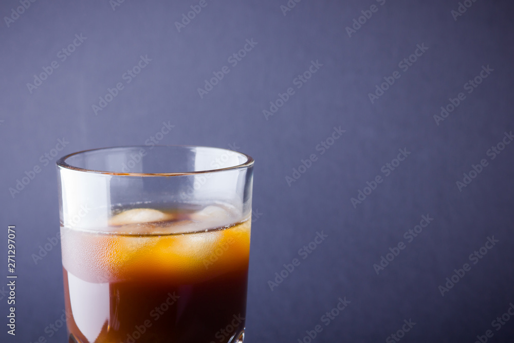 Iced coffee on a dark background. Summer drink with caffeine on the slate board. Iced coffee in a glass. Copy space Iced coffee on a dark background. Summer drink with caffeine on the slate board. Iced coffee in a glass. Copy space