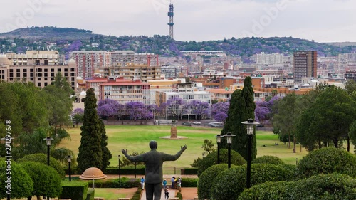 Jacaranda season view of Pretoria, Thswane, South Africa as seen from the Union Buildings, late afternoon timelapse until dusk/twilight with Madiba (Nelson Mandela) statue 4K 25p. photo
