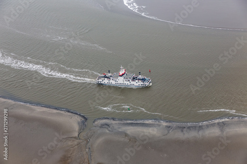 Dutch ferry boat at Wadden Sea navigating beween sandbanks photo