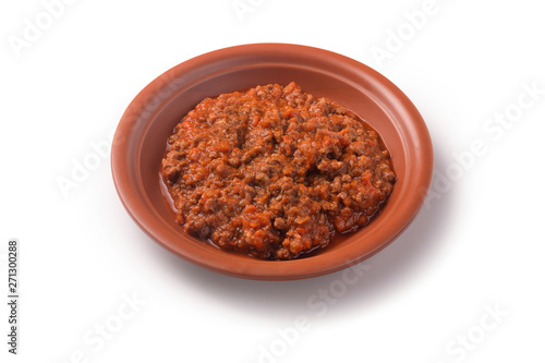 Fototapeta Naklejka Na Ścianę i Meble -  classic italian bolognese sauce stewed in a ceramic plate, isolated on white background