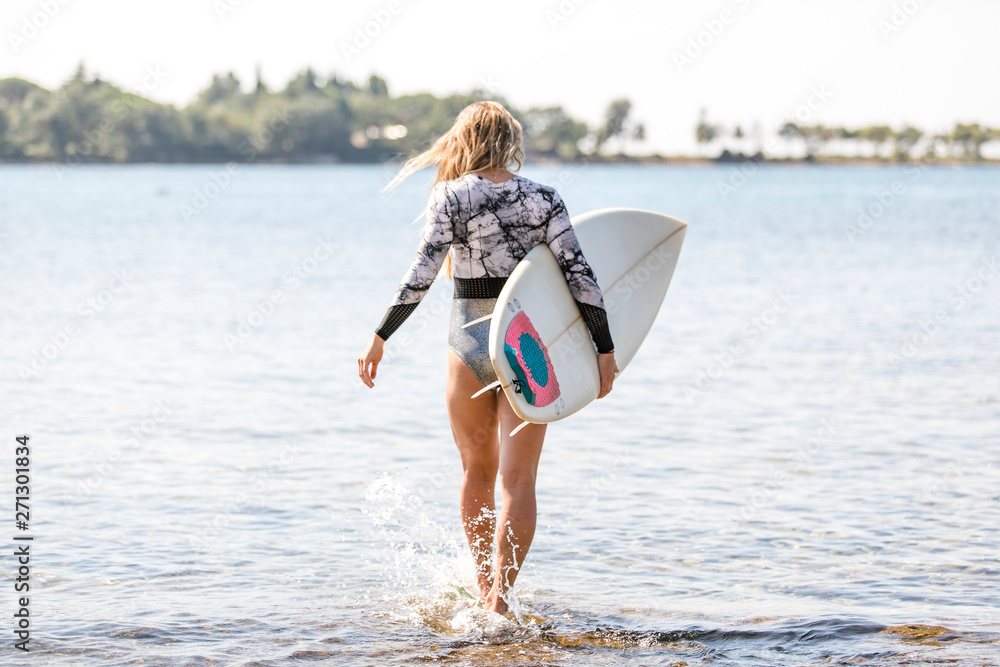 Sexy surf girl with long hair go to surfing. Young surfer woman holding  short surfboard on a beach Photos | Adobe Stock
