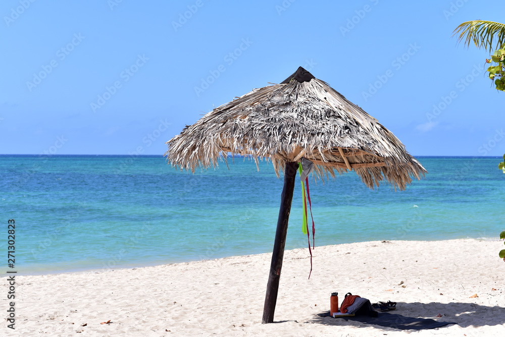 Sun umbrella stands on the beach of Playa Ancon in Trinidad, Cuba