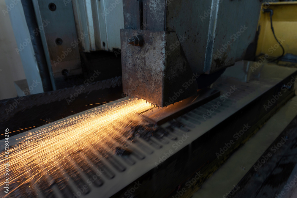 Grinding a metal part on a high-precision surface grinding machine with cooling. Grinding a metal part on a high-precision surface grinding machine with cooling.