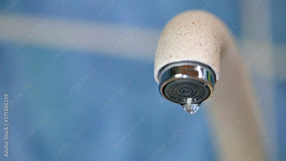 Dripping water from a water tap close-up. Faulty water faucet. Water leakage problem. Worldwide problem of safety of drinking fresh water. Conceptual video footage. Dripping water from a water tap close-up. Faulty water faucet. Water leakage problem. Worldwide problem of safety of drinking fresh water. Conceptual video footage.