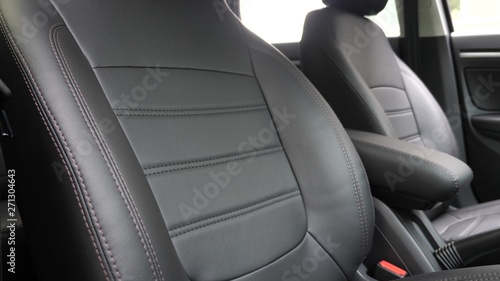 Black leather seat covers in the car. beautiful leather car interior design. stylish leather seats in the car. luxury leather seats in car.