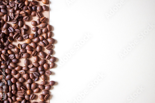 Coffee beans on braun background.