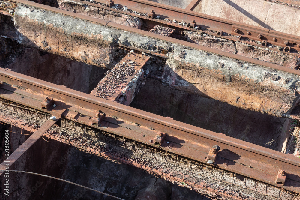 Very old elevated train tracks, rust and crumbling concrete, iron pellets, horizontal aspect Very old elevated train tracks, rust and crumbling concrete, iron pellets, horizontal aspect