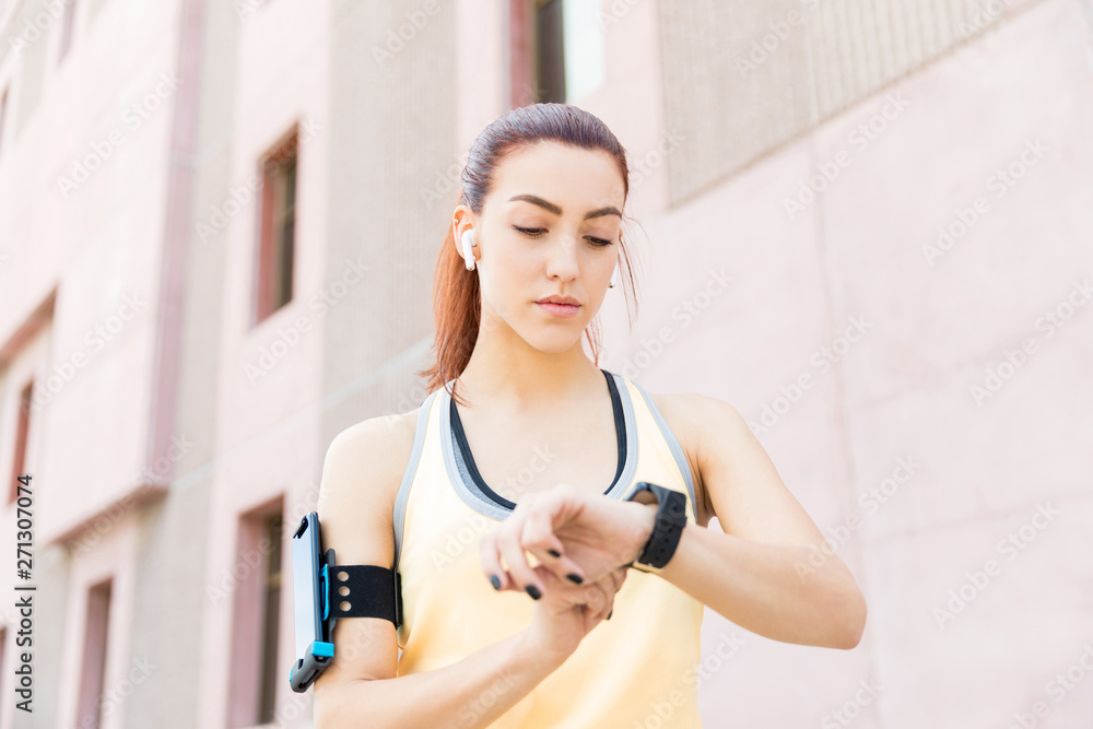 Woman Using Smart Watch To Measure Her Heart Rate Woman Using Smart Watch To Measure Her Heart Rate