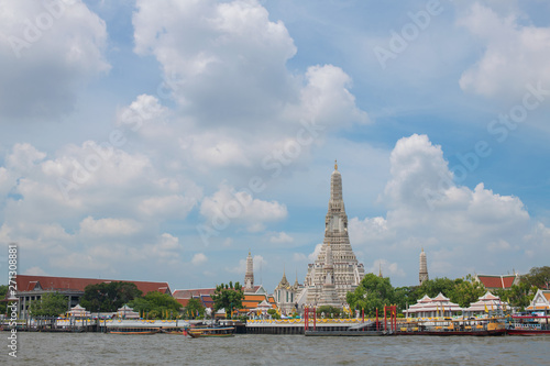 Wat Arun Temple located in Bangkok Thailand near River with the blue sky