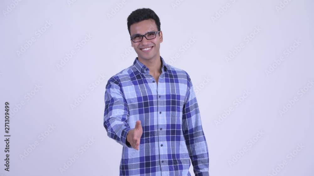 Happy young Indian hipster man giving handshake Happy young Indian hipster man giving handshake