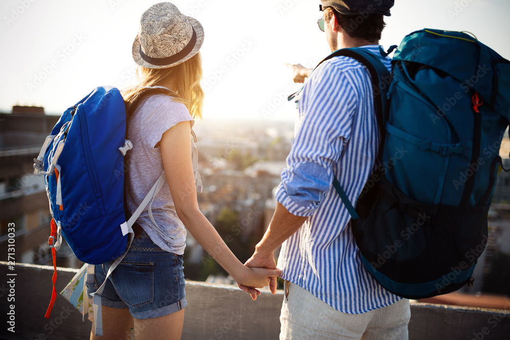 Multiethnic traveler couple using map together on sunny day Multiethnic traveler couple using map together on sunny day
