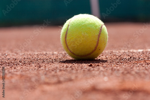 Close up of tennis ball on clay court. © dorotaam