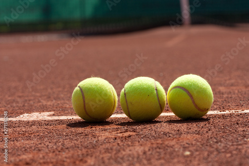 Close up of tennis balls on clay court. © dorotaam
