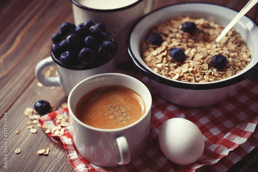 A healthy breakfast - oatmeal, boiled egg, milk, fresh berries and coffee. A great start to a new day. A healthy breakfast - oatmeal, boiled egg, milk, fresh berries and coffee. A great start to a new day.