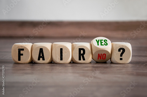 Cubes and dice with fair yes or no on wooden background photo