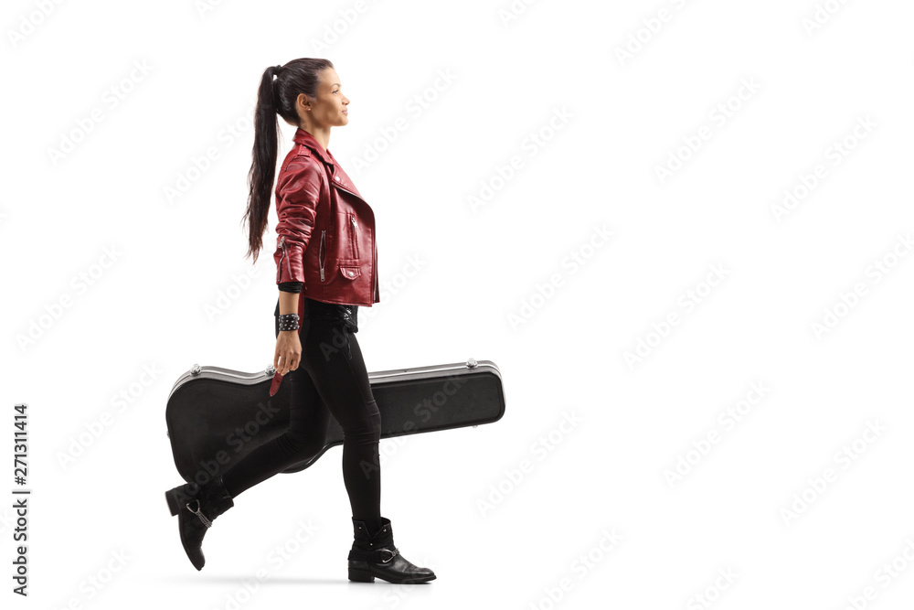 Fototapeta premium Female musician walking and carrying a guitar in a case