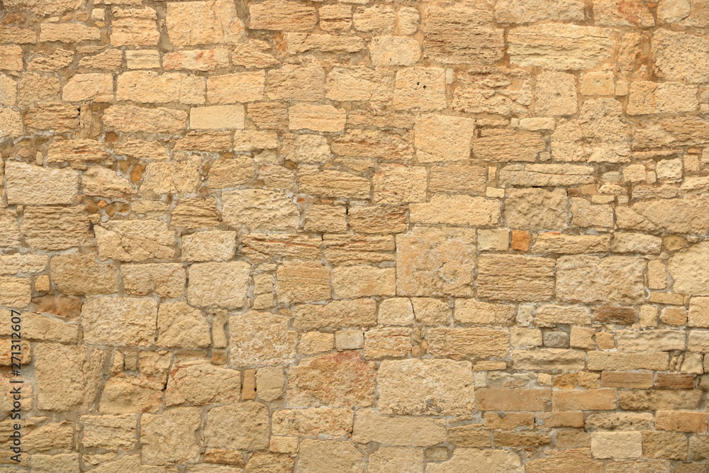 Fototapeta premium Big yellow wall from stone bricks