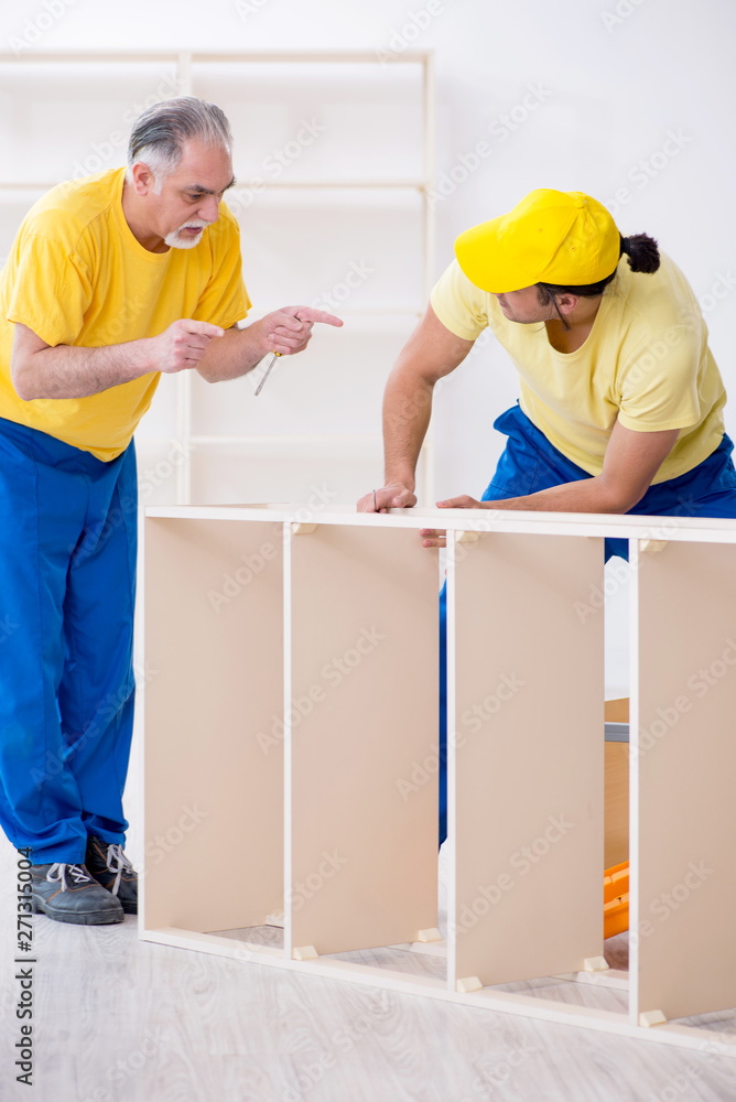 Two contractors carpenters working indoors Two contractors carpenters working indoors