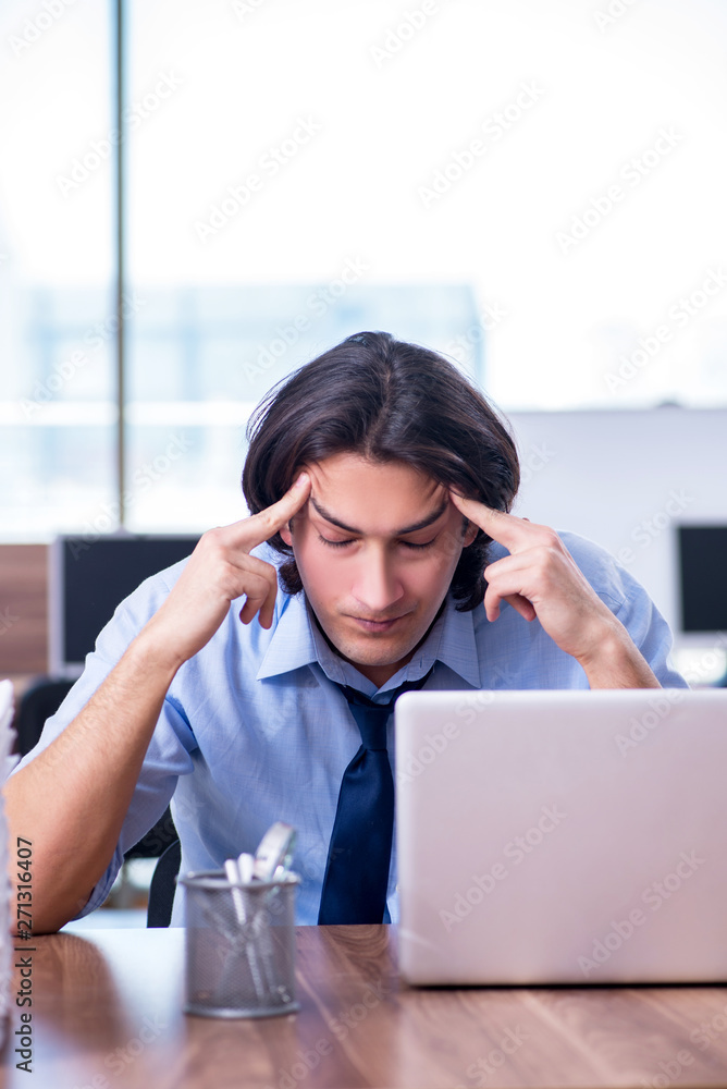 Young employee unhappy with excessive work Young employee unhappy with excessive work