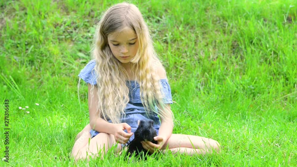 Adorable Blond Child Girl Reading Book Outside on Grass Adorable Blond Child Girl Reading Book Outside on Grass