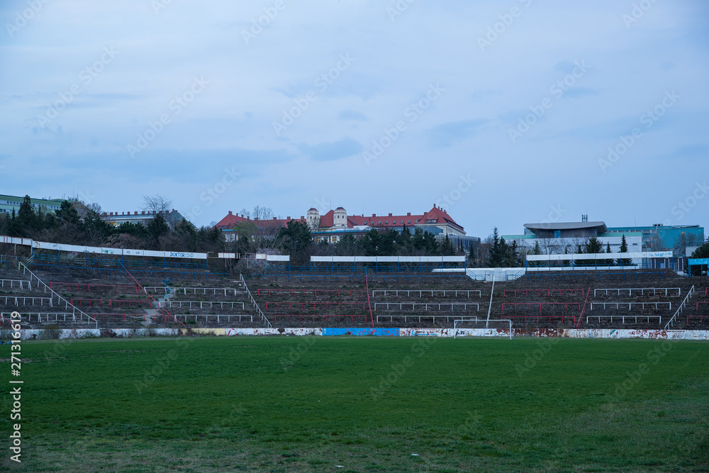 Abadoned Stadion Za Luzankami is a currently inactive stadium in Brno, Czech Republic. Captured in spring sunset, sky and clouds was colored to blue dark colors. Photo from tribunes and inside middle Abadoned Stadion Za Luzankami is a currently inactive stadium in Brno, Czech Republic. Captured in spring sunset, sky and clouds was colored to blue dark colors. Photo from tribunes and inside middle