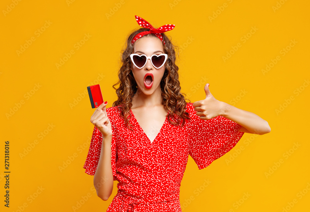 beautiful funny girl  with plastic credit card for shopping for yellow color background. - obrazy, fototapety, plakaty 