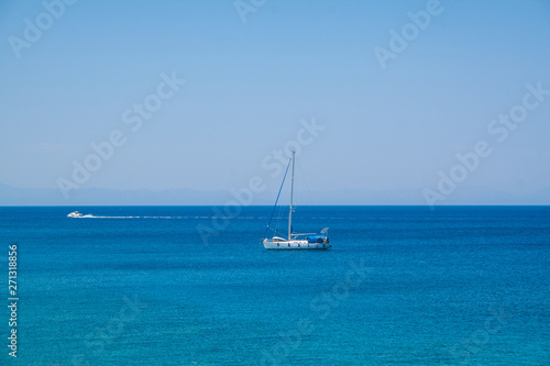 The yacht on the background of the mills in the Mediterranean harbor Mandraki. Rhodes Island. Greece © jaroslavkettner