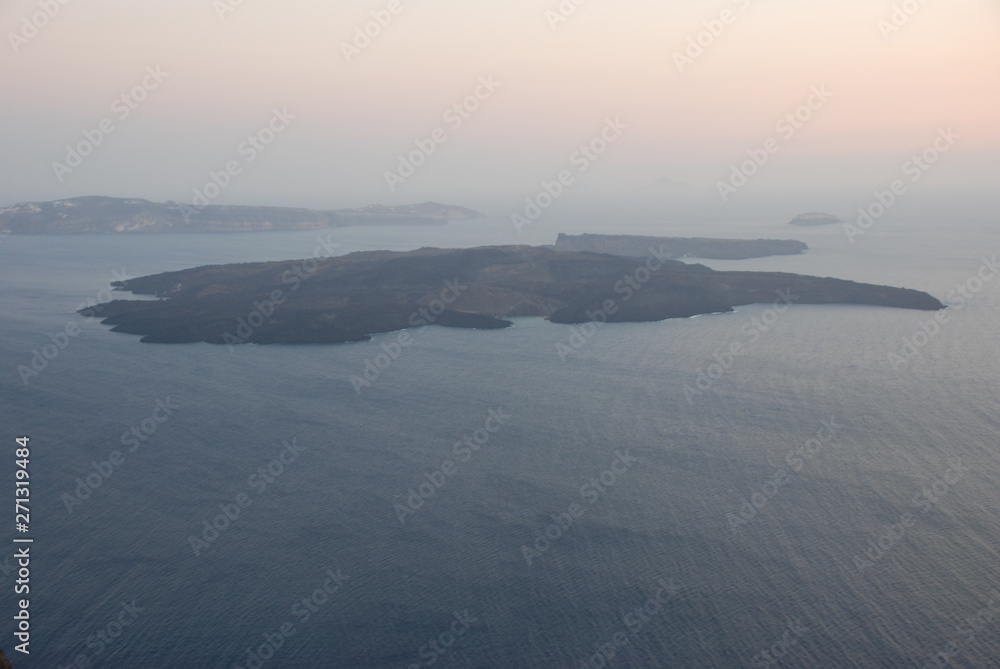 Obraz premium The volcano of Fira at Sunset as seen from the Santorini Island
