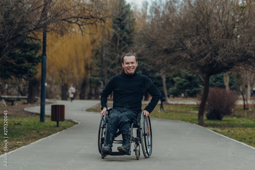 Portrait of a happy man on a wheelchair in a park Portrait of a happy man on a wheelchair in a park