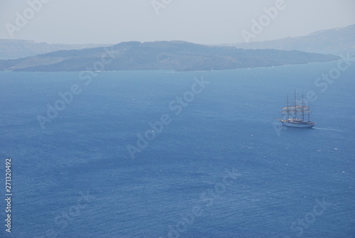 Ship sailing off the coast of Santorini Island