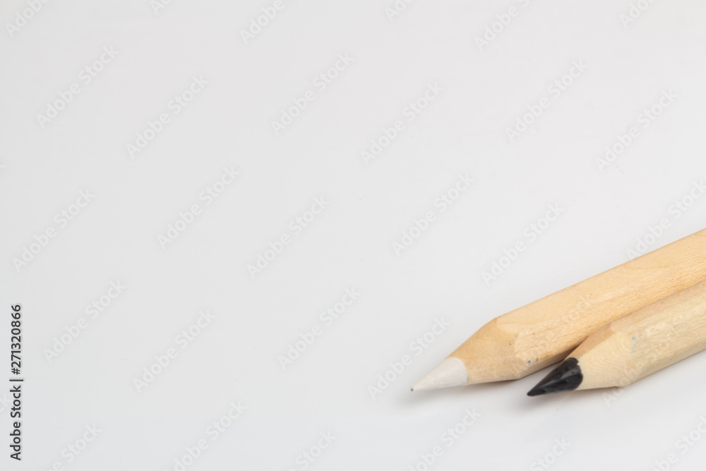 White and black pencils on white background White and black pencils on white background