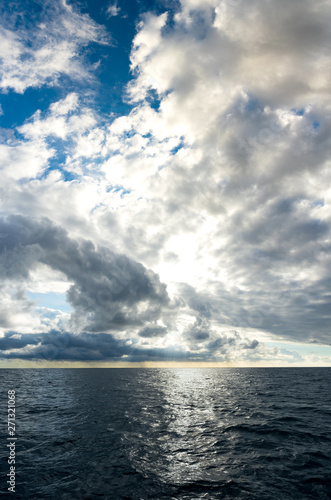 Storm clouds building up over dark blue ocean