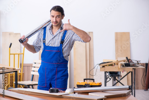 Young male carpenter working indoors 