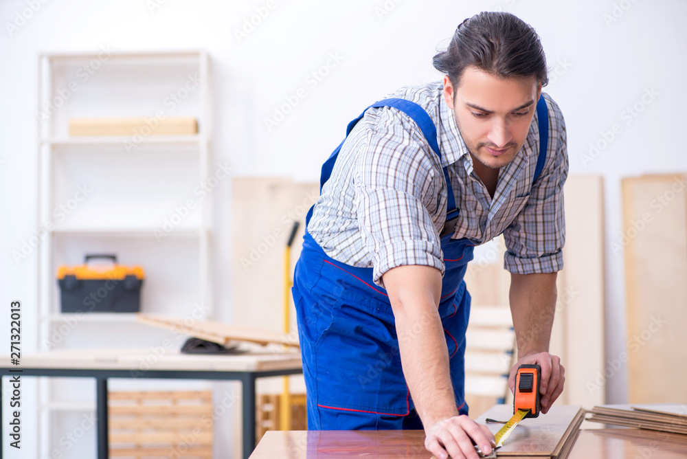 Young male carpenter working indoors Young male carpenter working indoors