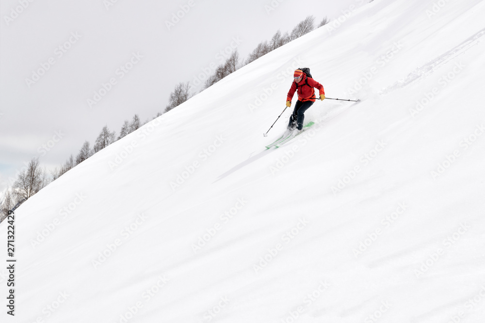 Georgia, Caucasus, Gudauri, man on a ski tour riding downhill Georgia, Caucasus, Gudauri, man on a ski tour riding downhill