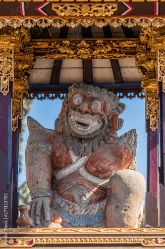 Ubud, Bali, Indonesia - February 26, 2019: Batuan Temple. Small shrine with animal icon in front right of Kori Agung, the main shrine, on Utama Mandala. Closeup of the figure. photo