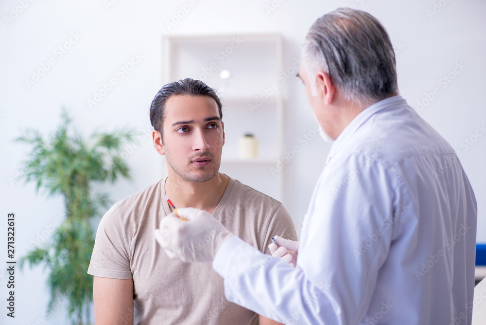 Male patient visitng doctor for shot inoculation Male patient visitng doctor for shot inoculation