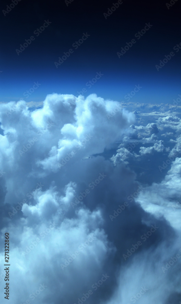 Fototapeta premium aerial view from plane, blue sky with clouds and sun