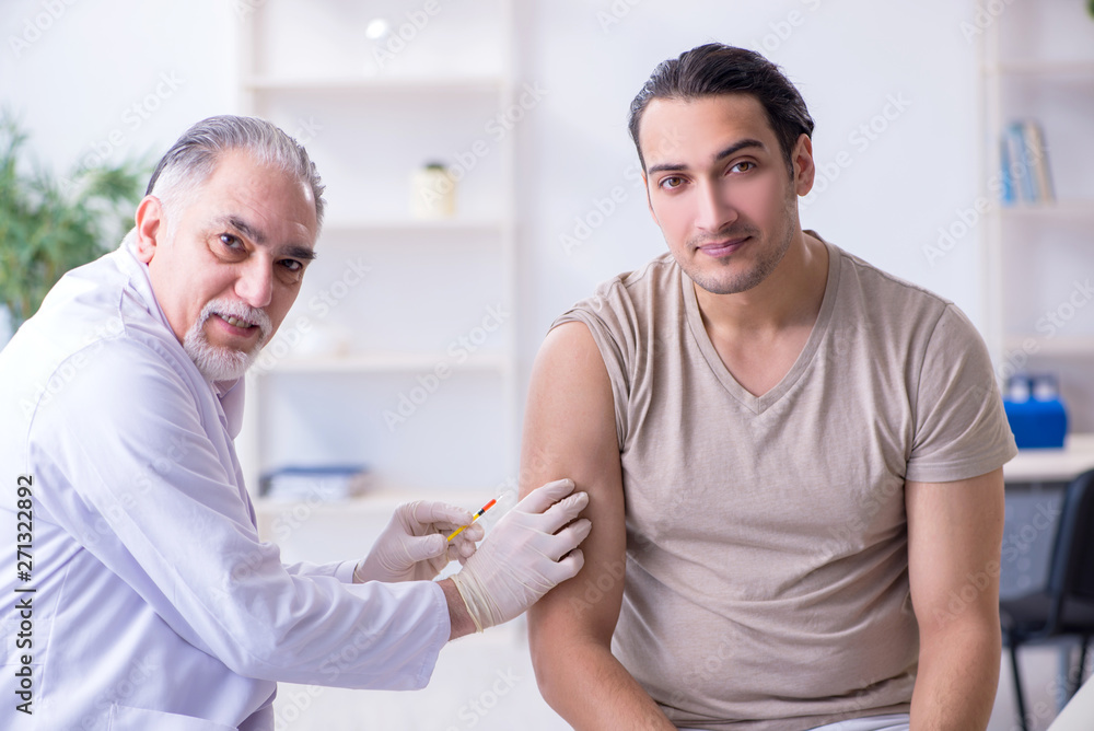Male patient visitng doctor for shot inoculation Male patient visitng doctor for shot inoculation
