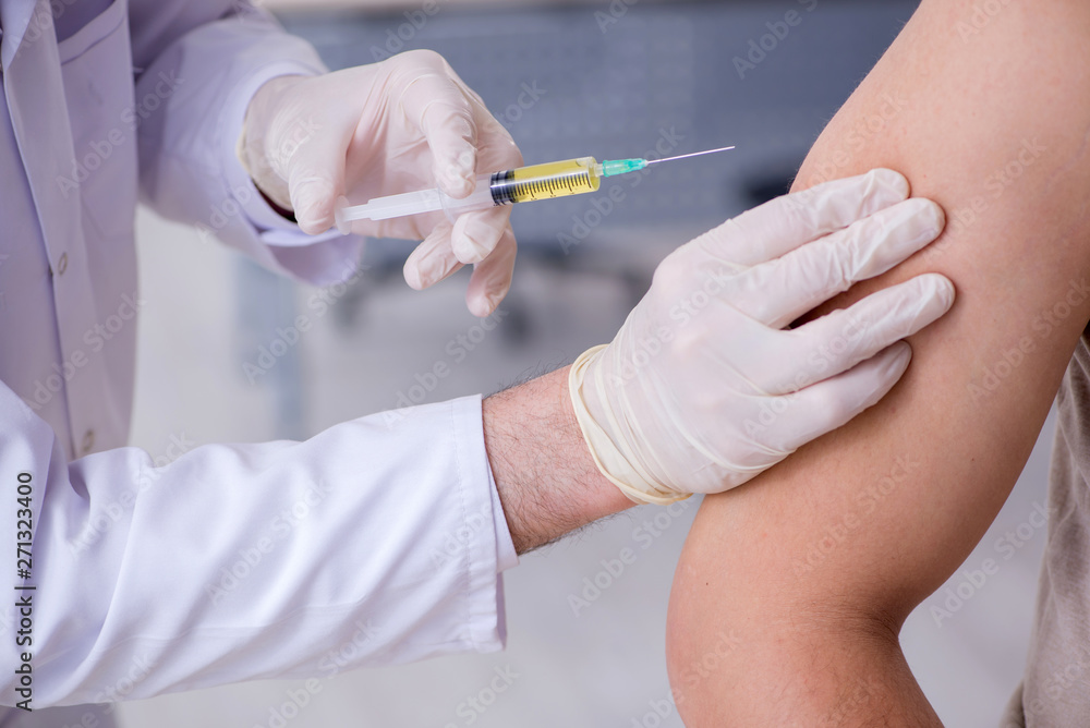 Male patient visitng doctor for shot inoculation Male patient visitng doctor for shot inoculation