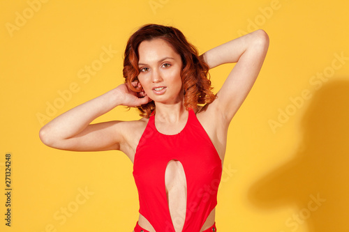 girl on yellow background with curly hair