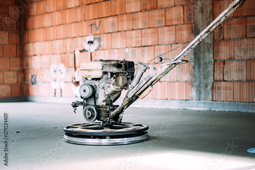 Helicopter concrete floor finishing. Construction worker finishing concrete screed with power trowel machine