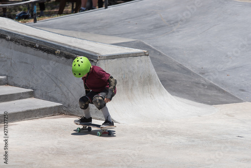 Little Boy Riding a Skateboard at a Skatepark