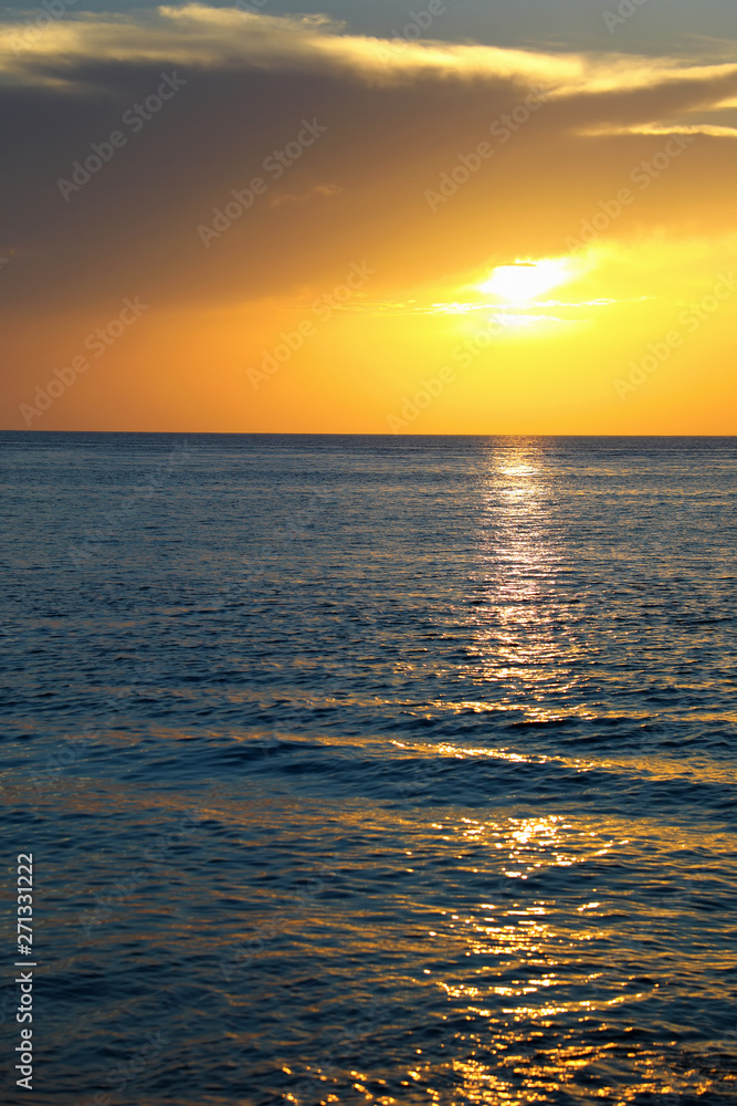 Colorful empty seascape with shiny sea over cloudy sky and sun during sunset in Cozumel, Mexico Colorful empty seascape with shiny sea over cloudy sky and sun during sunset in Cozumel, Mexico